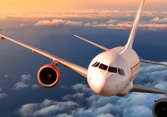 Airplane flying above clouds.